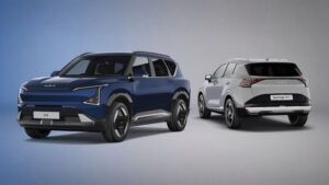 Kia adds Storm trim to EV5 and Sportage ranges A dark blue Kia EV5 electric SUV shown from the front and a light grey Kia Sportage HEV shown from the rear, both photographed in a studio against a blue-to-grey gradient background