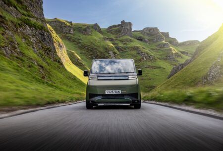Farizon adds sportier SV Sport variant to electric van range Alt text: Front-on view of a green Farizon SV Sport electric van driving along a road through a rocky, hill-lined valley, with "SPORT" badging visible beside the number plate